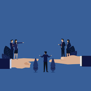 photo shows an illustration of two hands holding two groups of people with a person in the middle holding a scale.